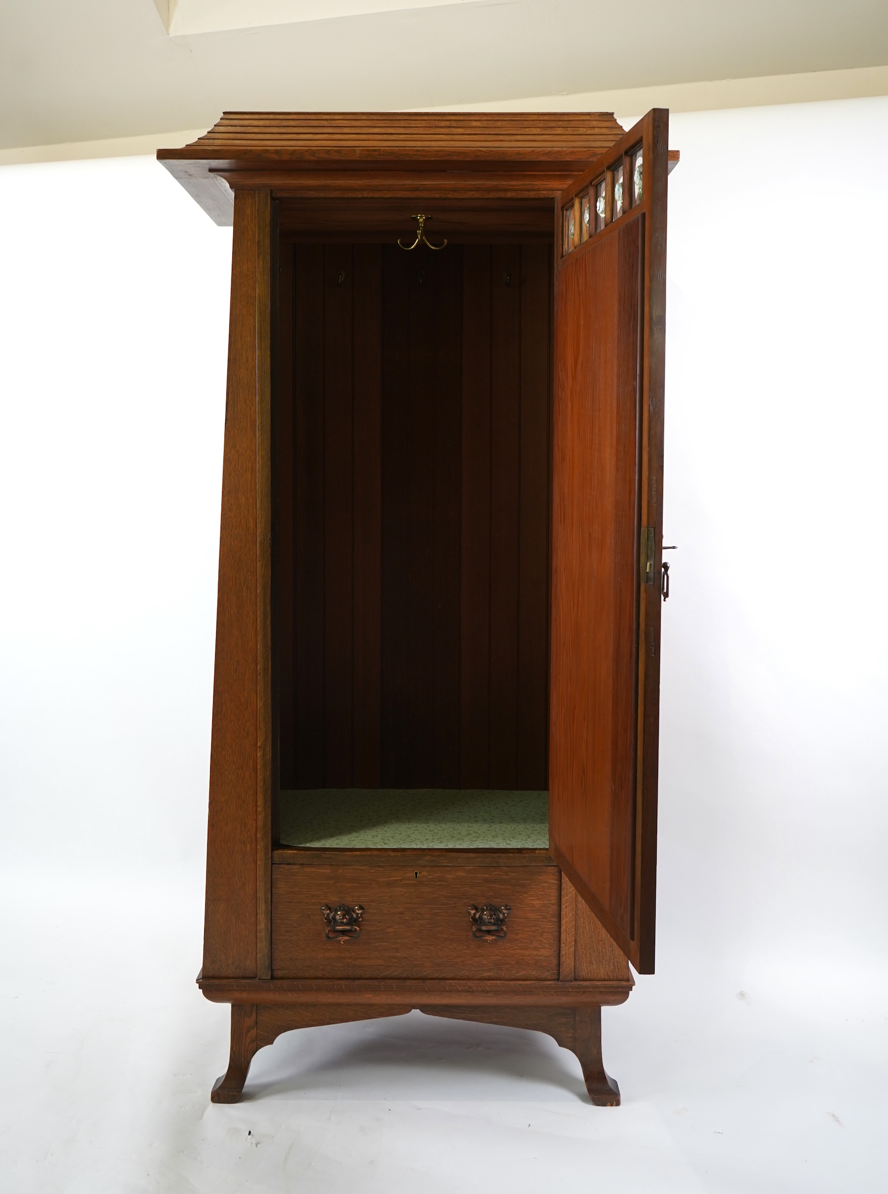 Manner of Liberty & Co: An Arts and Crafts Egyptian revival copper mounted oak wardrobe